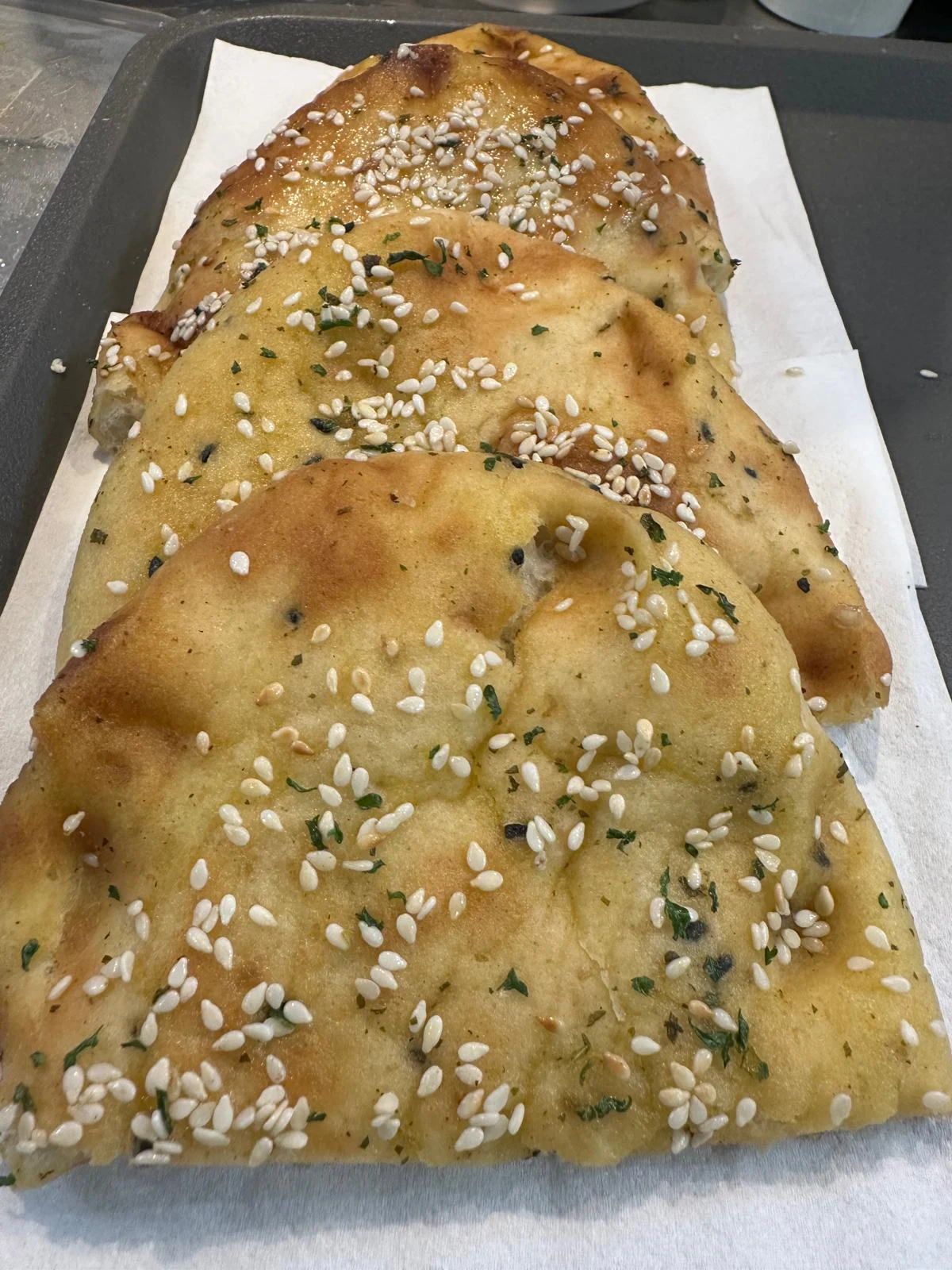 Golden naan topped with sesame seeds